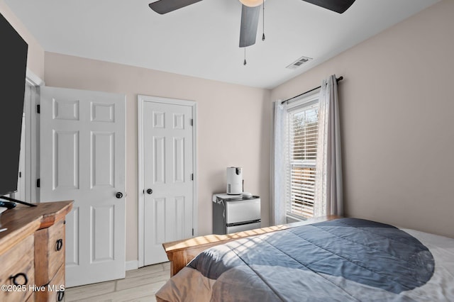 bedroom with ceiling fan and light wood-type flooring