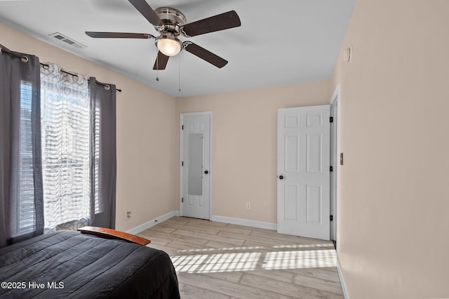 unfurnished bedroom with ceiling fan and light wood-type flooring