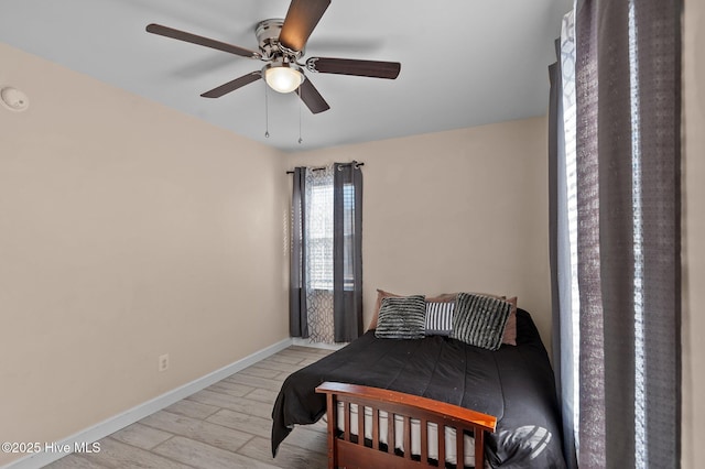 bedroom with ceiling fan and light hardwood / wood-style flooring