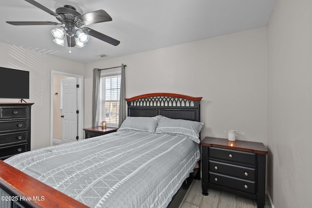 bedroom with ceiling fan and light hardwood / wood-style floors