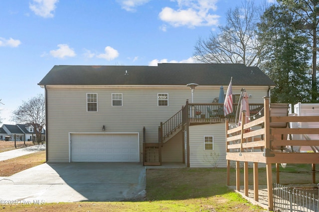 rear view of house featuring a garage