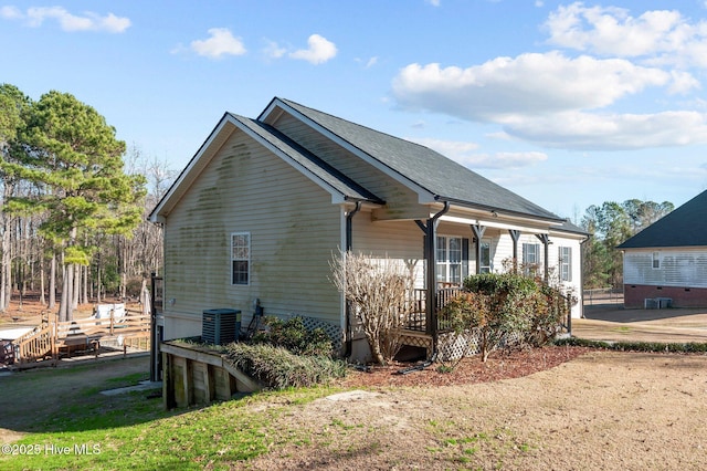 view of property exterior featuring central AC unit and a porch