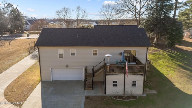 rear view of property featuring a yard and a garage