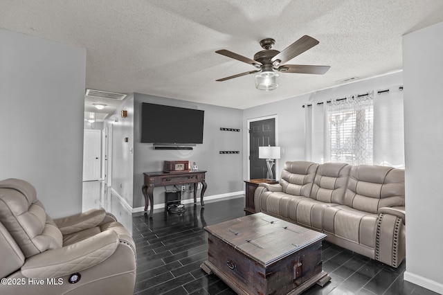 living room with a textured ceiling and ceiling fan