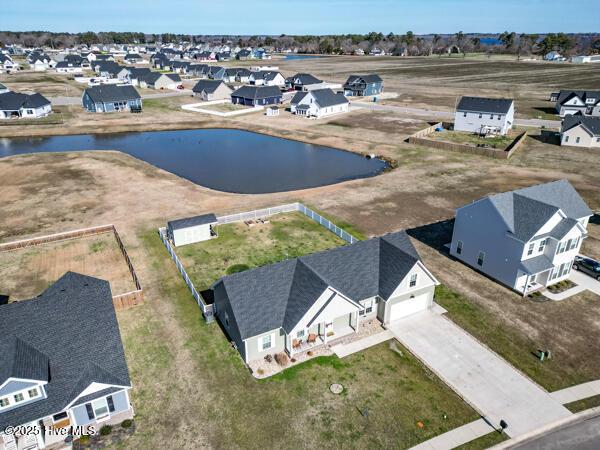 bird's eye view featuring a water view and a residential view