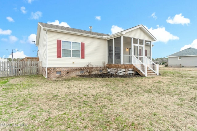 view of front of home with a sunroom and a front yard