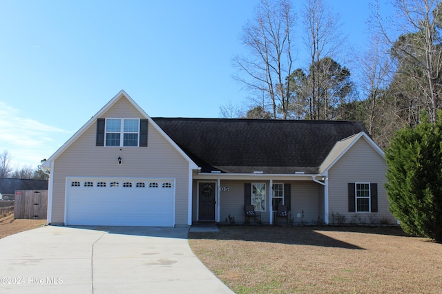 view of front of house featuring a garage and a front lawn