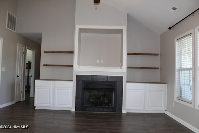 unfurnished living room with dark hardwood / wood-style floors, lofted ceiling, and a fireplace