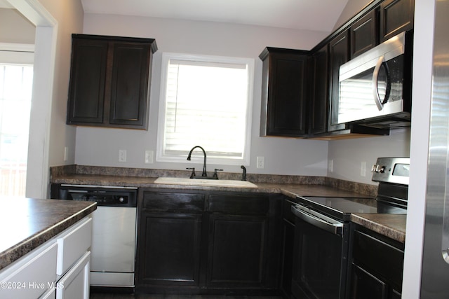 kitchen featuring dark brown cabinetry, sink, and appliances with stainless steel finishes