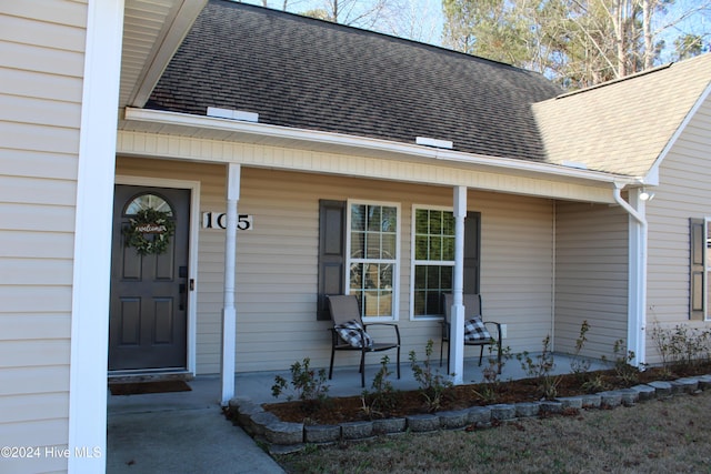 view of exterior entry featuring a porch