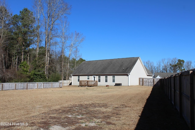 back of house featuring a wooden deck