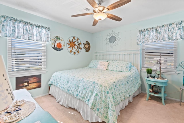 bedroom with ceiling fan and light carpet