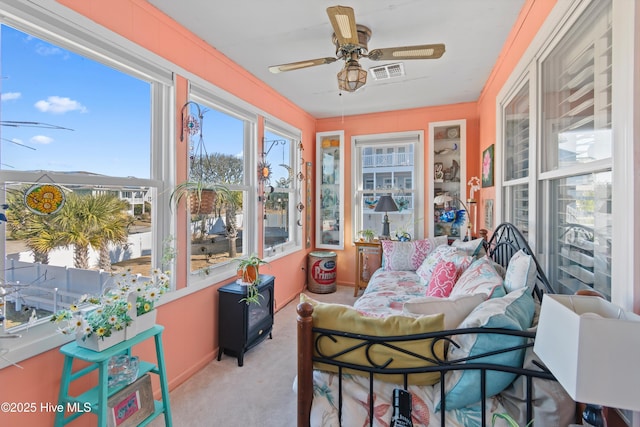 sunroom featuring ceiling fan