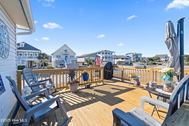 wooden terrace featuring a grill