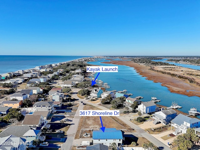 bird's eye view featuring a water view and a beach view