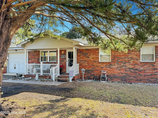 single story home with covered porch and a garage