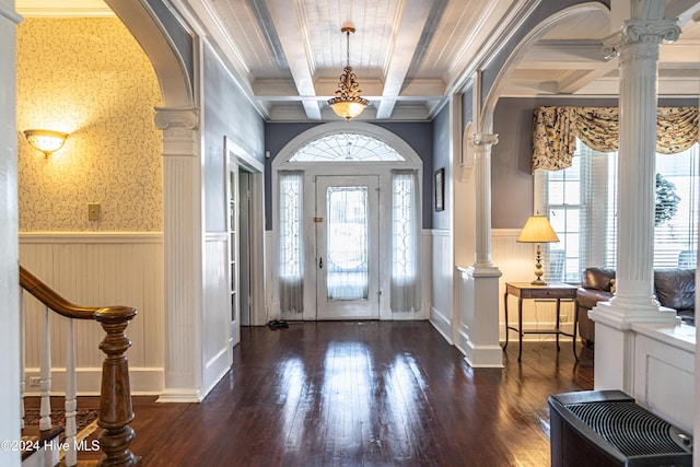 foyer entrance featuring ornate columns, ornamental molding, coffered ceiling, beam ceiling, and dark hardwood / wood-style floors