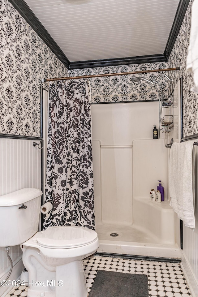 bathroom featuring a shower, toilet, and ornamental molding