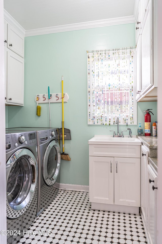 laundry room featuring sink, cabinets, washing machine and dryer, light tile patterned flooring, and ornamental molding