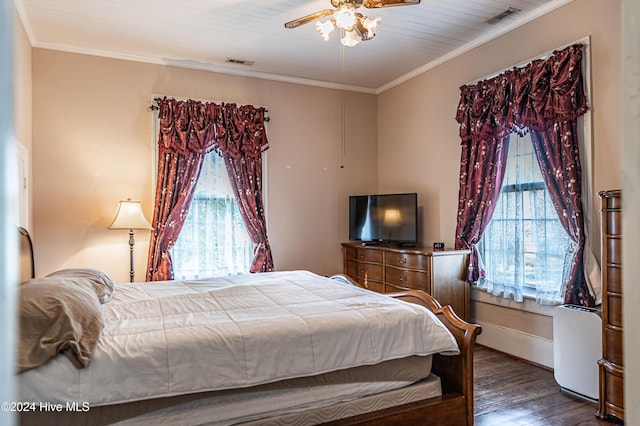 bedroom with ornamental molding, ceiling fan, and dark wood-type flooring