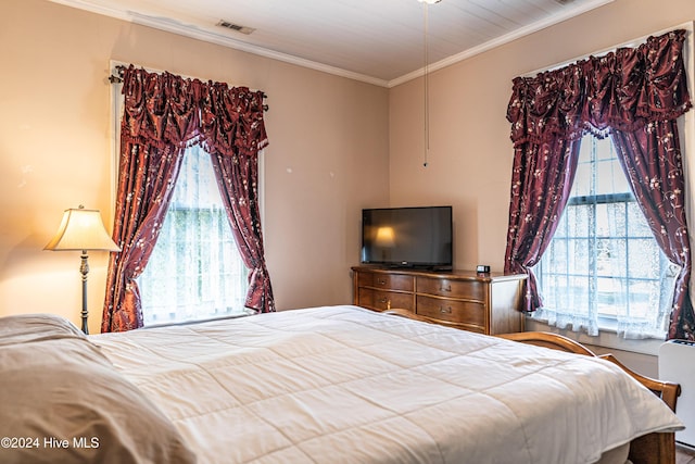 bedroom featuring multiple windows and ornamental molding