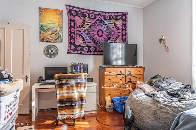 bedroom with wood-type flooring and crown molding