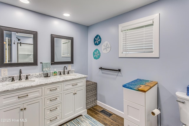 bathroom featuring hardwood / wood-style flooring, vanity, and toilet