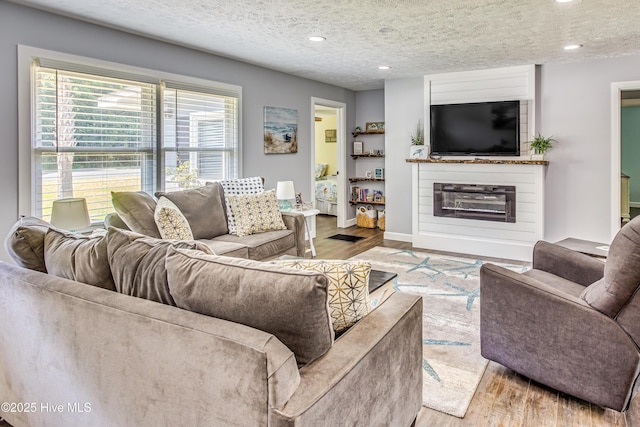 living room featuring a textured ceiling and light hardwood / wood-style flooring