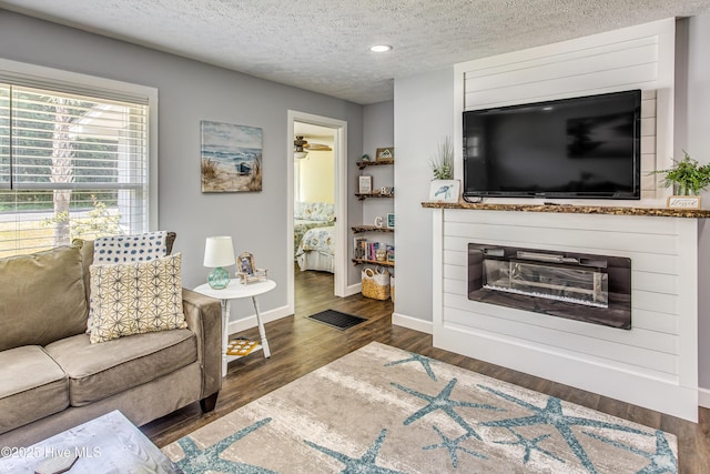 living room featuring dark hardwood / wood-style floors and a textured ceiling