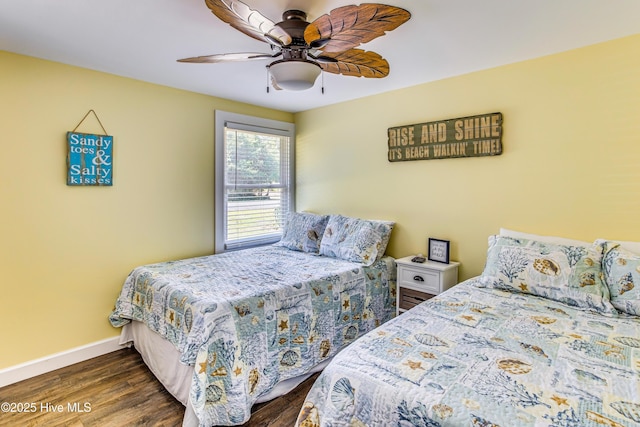 bedroom with dark hardwood / wood-style flooring and ceiling fan