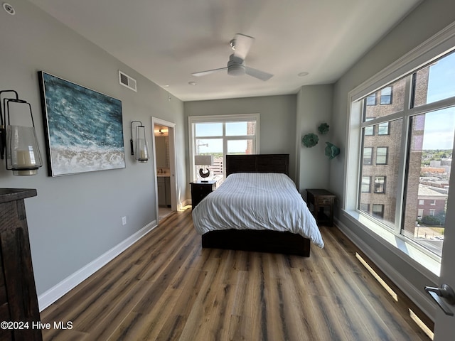 bedroom with dark hardwood / wood-style flooring, ensuite bath, and ceiling fan