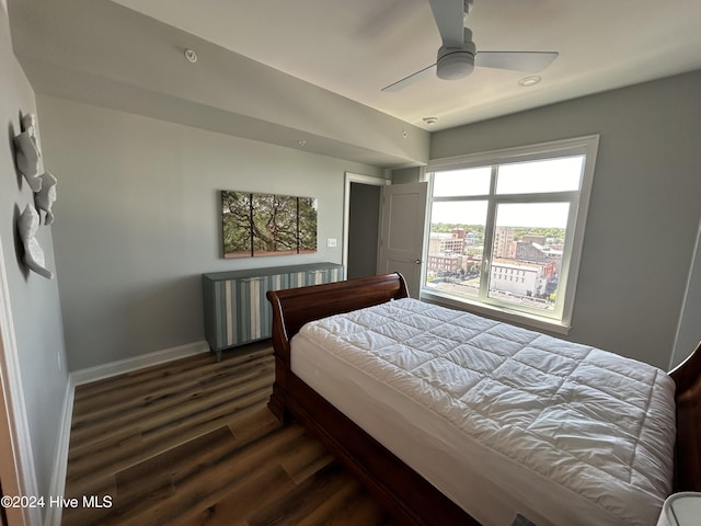 bedroom with dark hardwood / wood-style flooring, radiator, and ceiling fan