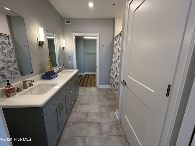 bathroom featuring vanity and curtained shower