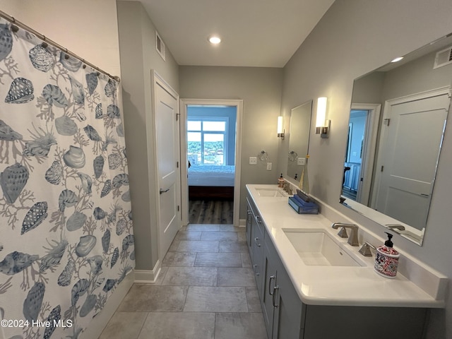 bathroom featuring vanity and curtained shower