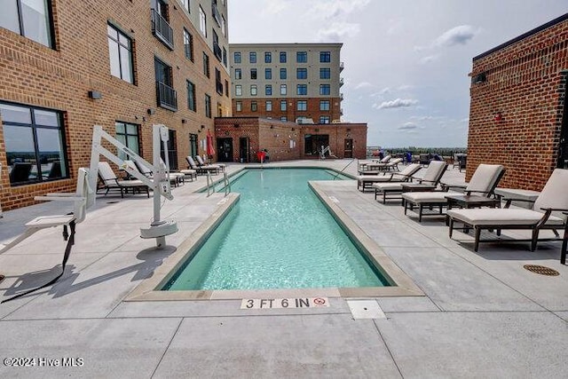 view of swimming pool with a patio