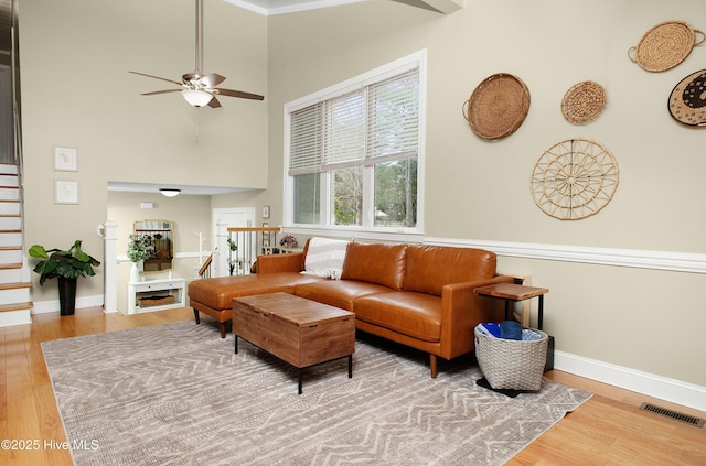 living room with ceiling fan and wood-type flooring