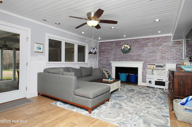 living room with ceiling fan, ornamental molding, light hardwood / wood-style floors, brick wall, and wood ceiling