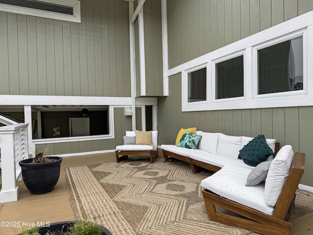 wooden terrace featuring an outdoor living space