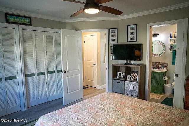 bedroom with light hardwood / wood-style floors, ceiling fan, ensuite bathroom, and ornamental molding