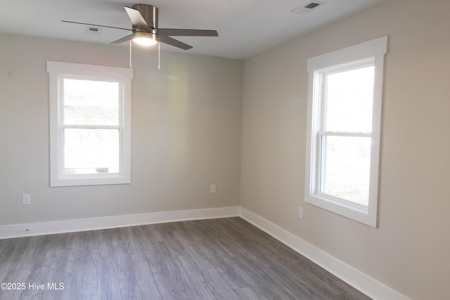 empty room with ceiling fan and hardwood / wood-style floors