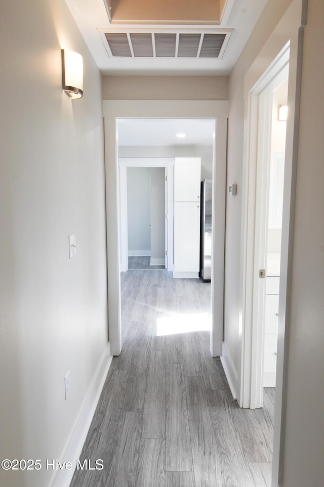 hallway with hardwood / wood-style flooring