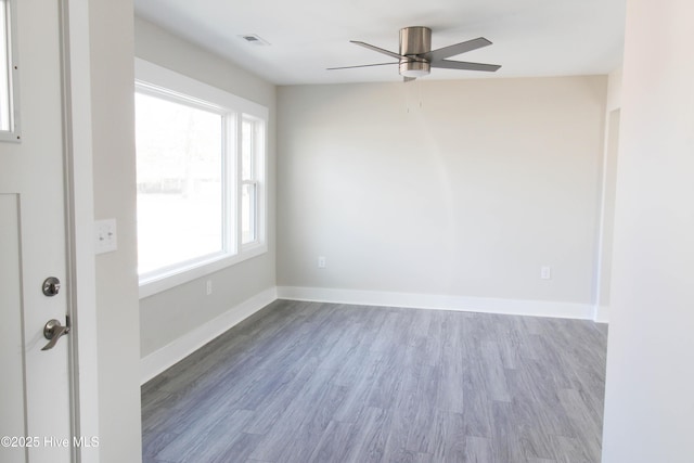 spare room featuring hardwood / wood-style flooring, plenty of natural light, and ceiling fan