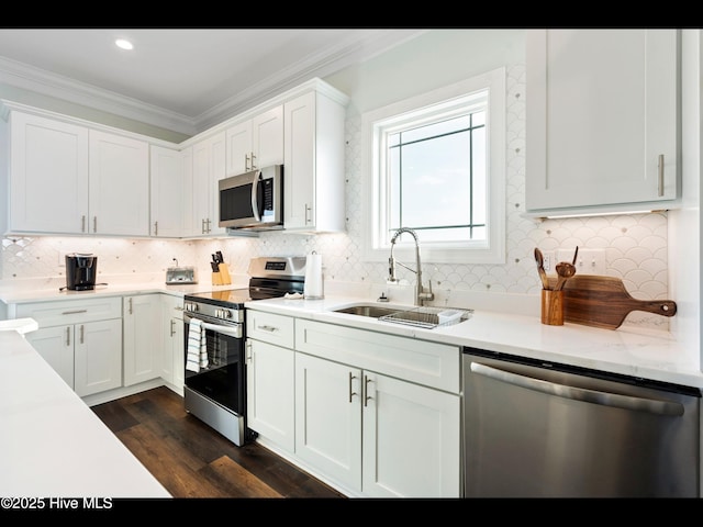 2083 New River Inlet Rd Unit A, North Topsail Beach, NC 28460 - kitchen featuring stainless steel appliances, a sink, ornamental molding, backsplash, and white cabinets