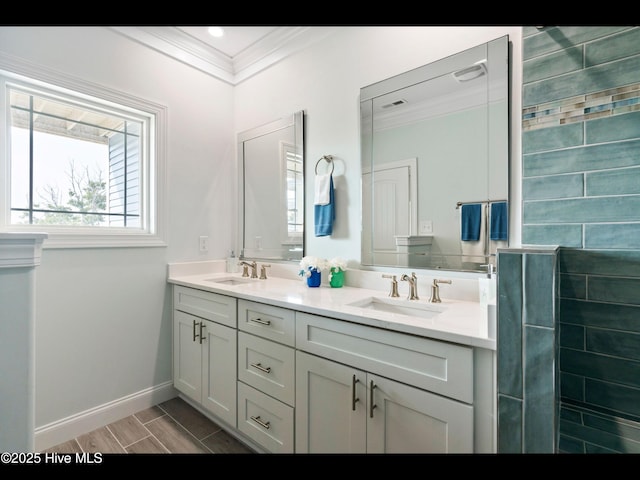 2083 New River Inlet Rd Unit A, North Topsail Beach, NC 28460 - bathroom featuring crown molding, double vanity, baseboards, and wood finish floors