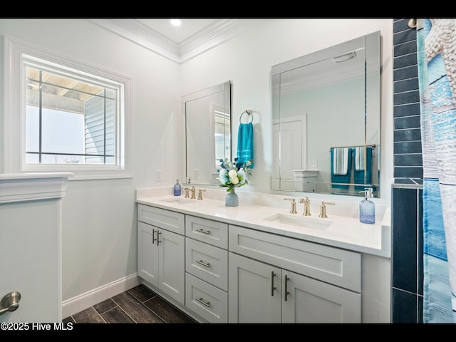 2083 New River Inlet Rd Unit A, North Topsail Beach, NC 28460 - full bathroom with crown molding, double vanity, wood finished floors, and baseboards