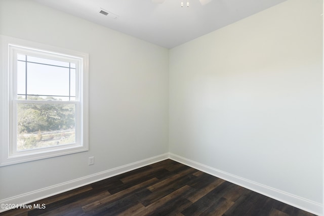 unfurnished room featuring dark hardwood / wood-style floors and ceiling fan