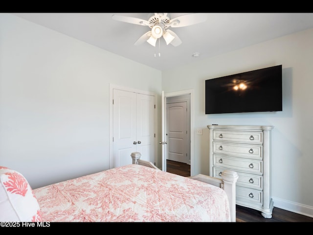 2083 New River Inlet Rd Unit A, North Topsail Beach, NC 28460 - bedroom with dark wood-type flooring, baseboards, a closet, and a ceiling fan