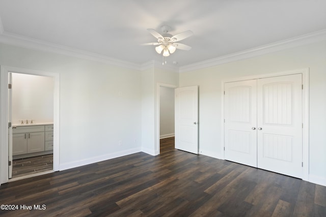 unfurnished bedroom with a closet, ceiling fan, crown molding, and dark hardwood / wood-style floors