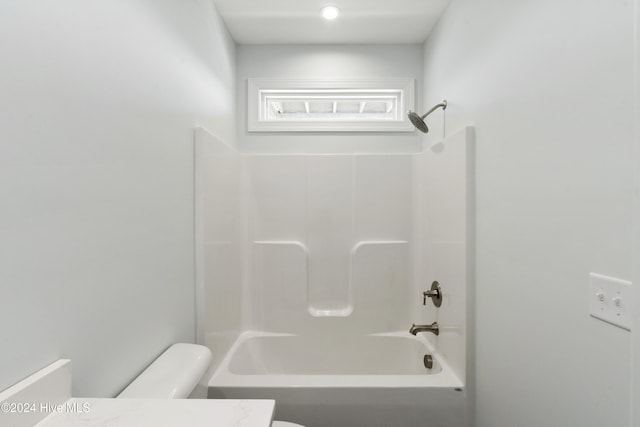 bathroom featuring toilet and shower / tub combination