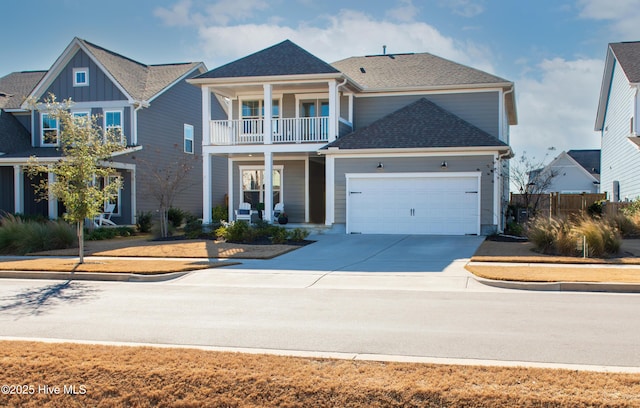 view of front of property featuring a balcony and a garage